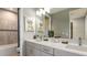 Bathroom with double sinks, a large mirror, and a tub at 16431 Star Grass Cir, Bradenton, FL 34211