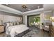Main bedroom with king-size bed, access to a screened lanai, and a sitting area at 16431 Star Grass Cir, Bradenton, FL 34211