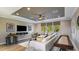 Loft area with sectional sofa, shuffleboard, and entertainment center at 16431 Star Grass Cir, Bradenton, FL 34211