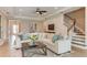 Open living room with sectional sofa, hardwood floors, and staircase at 16443 Star Grass Cir, Bradenton, FL 34211