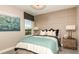 Cozy bedroom with window, neutral color palette, and wood nightstand at 16443 Star Grass Cir, Bradenton, FL 34211