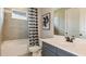 Clean bathroom with gray vanity, checkered shower curtain, and white tile at 16443 Star Grass Cir, Bradenton, FL 34211