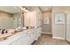 Double vanity bathroom with marble countertops and large shower at 16443 Star Grass Cir, Bradenton, FL 34211