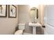Modern powder room with pedestal sink and oval mirror at 16443 Star Grass Cir, Bradenton, FL 34211