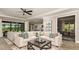 Spacious living room with large sectional sofa and wood coffee table at 16443 Star Grass Cir, Bradenton, FL 34211