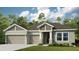 Two-story house with three-car garage and landscaping at 16443 Star Grass Cir, Bradenton, FL 34211