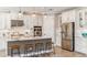 Modern kitchen featuring white cabinets, a large island, and stainless steel appliances at 16443 Star Grass Cir, Bradenton, FL 34211