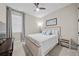 Bedroom with a queen bed, window with blinds, and a desk area at 16742 Savory Mist Cir, Bradenton, FL 34211