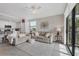 Open living room with two sofas and a view into the kitchen at 17626 Gawthrop Dr # 201, Bradenton, FL 34211