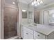 Modern bathroom with a walk-in shower and quartz countertop at 17626 Gawthrop Dr # 201, Bradenton, FL 34211
