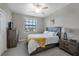 Comfortable bedroom with a queen-size bed and a dresser at 17626 Gawthrop Dr # 201, Bradenton, FL 34211