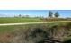 Landscaped green space with a walkway next to a golf course at 17626 Gawthrop Dr # 201, Bradenton, FL 34211