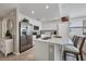 Open concept kitchen with white cabinets and stainless steel appliances at 17626 Gawthrop Dr # 201, Bradenton, FL 34211