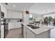 Modern kitchen with island, stainless steel appliances, and white cabinets at 17626 Gawthrop Dr # 201, Bradenton, FL 34211