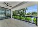 Covered balcony with a ceiling fan, offering serene outdoor views and access from the bedroom through glass doors at 2038 Datura St, Sarasota, FL 34239