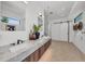 Modern bathroom features double sinks, a marble countertop, a barn door, and recessed lighting at 2038 Datura St, Sarasota, FL 34239