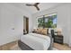 Modern bedroom featuring a ceiling fan, a large window, and neutral decor at 2038 Datura St, Sarasota, FL 34239