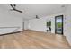 Large bedroom with light hardwood floors, white walls, and access to a balcony at 2038 Datura St, Sarasota, FL 34239