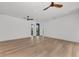 Bright, minimalist bedroom featuring hardwood floors and ceiling fans at 2038 Datura St, Sarasota, FL 34239