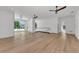 Spacious bedroom featuring hardwood floors, ceiling fans, and glass entryway to balcony at 2038 Datura St, Sarasota, FL 34239
