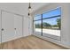 Bright bedroom featuring hardwood floors, a large window, and sliding closet doors at 2038 Datura St, Sarasota, FL 34239