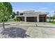Modern home featuring a sleek design, concrete driveway with grass accents, and ample parking space at 2038 Datura St, Sarasota, FL 34239