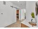 Hallway with white barn doors leading to a laundry room with modern marble counters at 2038 Datura St, Sarasota, FL 34239