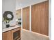 Hallway with view into the kitchen, featuring wood cabinets, marble counters, and modern appliances at 2038 Datura St, Sarasota, FL 34239
