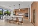 Modern kitchen with a large marble island, wooden cabinets, and stainless steel appliances at 2038 Datura St, Sarasota, FL 34239