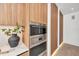 Elegant kitchen featuring built-in stainless steel appliances and sleek wood cabinetry at 2038 Datura St, Sarasota, FL 34239
