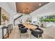 Open living space with a dining area, modern staircase, and luxury design at 2038 Datura St, Sarasota, FL 34239