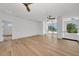 Spacious living room with hardwood floors, a ceiling fan, and large glass entryway at 2038 Datura St, Sarasota, FL 34239
