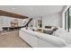 Open living room with a marble fireplace, floating stairs, and stylish decor at 2038 Datura St, Sarasota, FL 34239