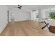 Bright living room featuring hardwood floors, ceiling fans, and staircase with glass railing at 2038 Datura St, Sarasota, FL 34239