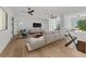 Bright living room featuring hardwood floors, a comfortable sofa, and modern decor at 2038 Datura St, Sarasota, FL 34239