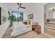 Comfortable main bedroom featuring hardwood floors, modern lighting, a ceiling fan, and glass doors to a balcony at 2038 Datura St, Sarasota, FL 34239