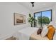 Inviting bedroom with a neutral palette, framed artwork, a modern ceiling fan, and a glass door to the balcony at 2038 Datura St, Sarasota, FL 34239