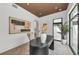 Bright office space with a large window showcasing the greenery and wood paneled ceiling at 2038 Datura St, Sarasota, FL 34239