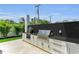Outdoor kitchen featuring a built-in grill, countertop space, and storage cabinets, perfect for outdoor entertaining at 2038 Datura St, Sarasota, FL 34239
