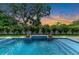 Inviting backyard pool and spa area with lush landscaping and stylish accents at 2038 Datura St, Sarasota, FL 34239