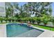 Inviting outdoor pool area with a spa and lush landscaping, offering a serene and relaxing backyard retreat at 2038 Datura St, Sarasota, FL 34239