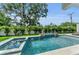 Inviting backyard pool and spa area with lush landscaping and stylish accents at 2038 Datura St, Sarasota, FL 34239