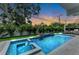 Inviting backyard pool and spa area with lush landscaping and stylish accents at 2038 Datura St, Sarasota, FL 34239