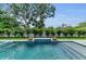 Inviting backyard pool and spa area with lush landscaping and stylish accents at 2038 Datura St, Sarasota, FL 34239