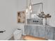 Modern powder room features a stone sink, floating vanity, pendant lights, and geometric wall art at 2038 Datura St, Sarasota, FL 34239