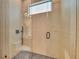 Close-up of a modern, glass-enclosed shower with unique tiling at 2038 Datura St, Sarasota, FL 34239