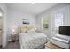 Bright bedroom with a queen bed, window, and private door at 2344 Lindstrom St, Sarasota, FL 34237