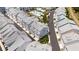 Aerial view of a community of townhouses with a pool and surrounding green space at 2344 Lindstrom St, Sarasota, FL 34237