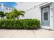 Modern home with gray door and lush landscaping at 2344 Lindstrom St, Sarasota, FL 34237