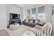 Living area with gray sofa and blue media console at 2344 Lindstrom St, Sarasota, FL 34237